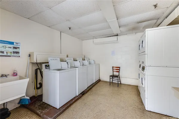 a view of a storage & utility room with two washing machine
