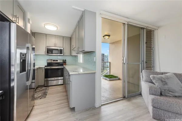 a kitchen with stainless steel appliances a refrigerator and a stove top oven