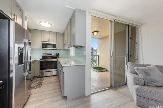 a kitchen with stainless steel appliances a refrigerator and a stove top oven