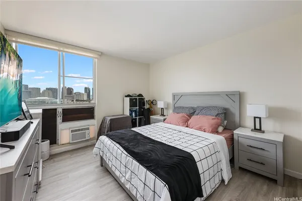 a bedroom with a bed and a large window