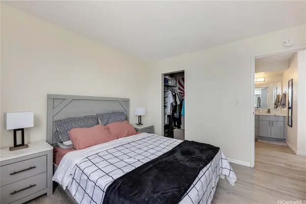 a bedroom with a bed and wooden floor