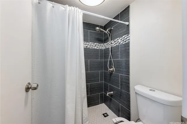 a bathroom with a toilet and shower