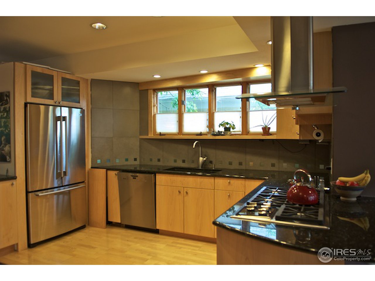 644 Dewey Avenue Boulder, CO 80304 - Photo 7 of 14 a kitchen with stainless steel appliances granite countertop a sink stove and refrigerator