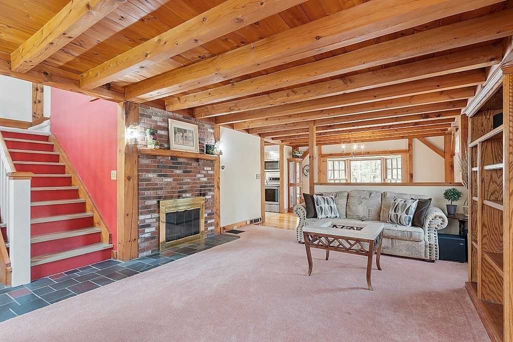 149 Walker Pond Road Sturbridge, MA 01566 - Photo 11 of 42 a living room with furniture and a fireplace