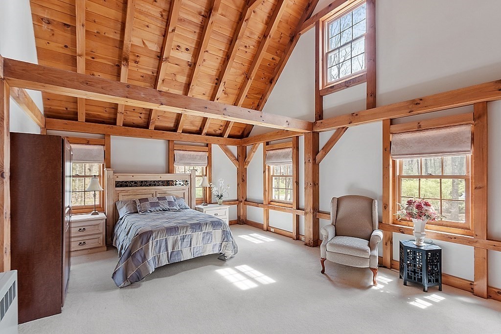 149 Walker Pond Road Sturbridge, MA 01566 - Photo 12 of 42 a bedroom with furniture and a large window