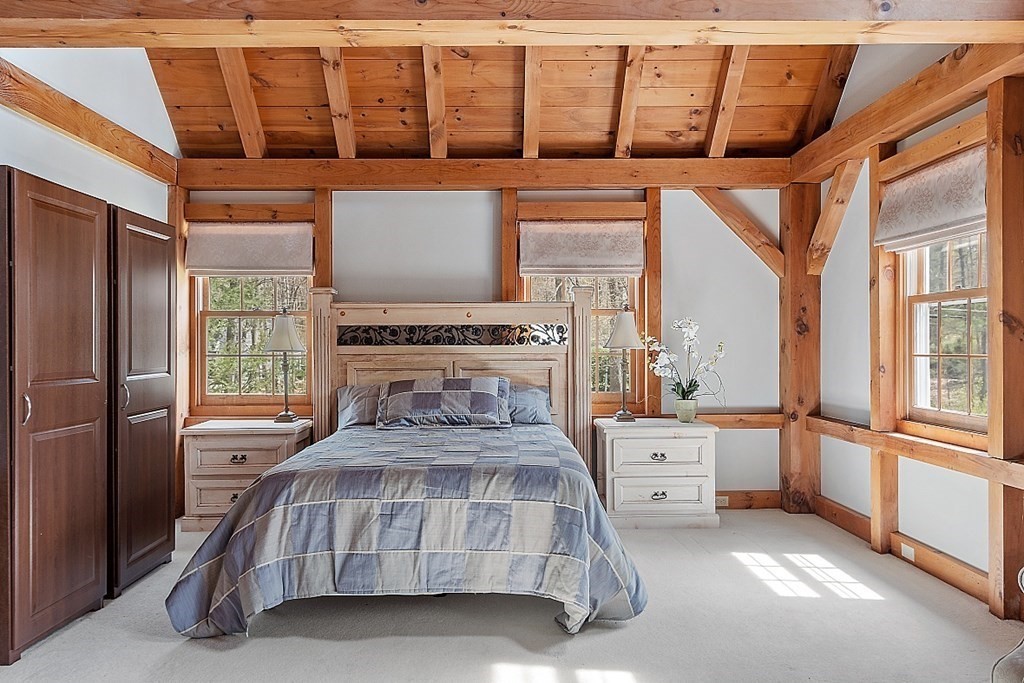 149 Walker Pond Road Sturbridge, MA 01566 - Photo 13 of 42 a bedroom with a bed next to a large window