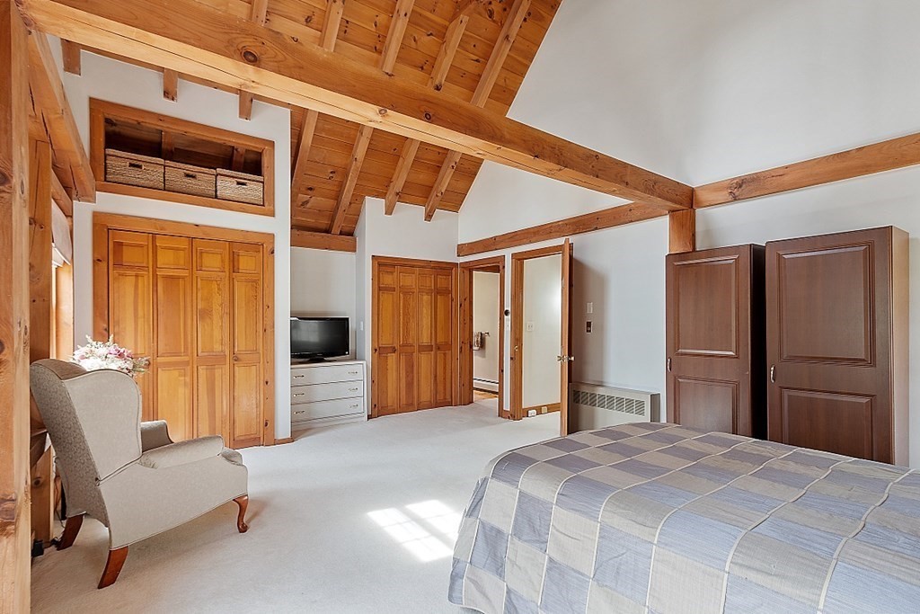 149 Walker Pond Road Sturbridge, MA 01566 - Photo 14 of 42 a bedroom with a bed and a chair