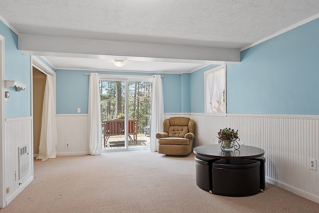 149 Walker Pond Road Sturbridge, MA 01566 - Photo 27 of 42 a living room with furniture and a floor to ceiling window