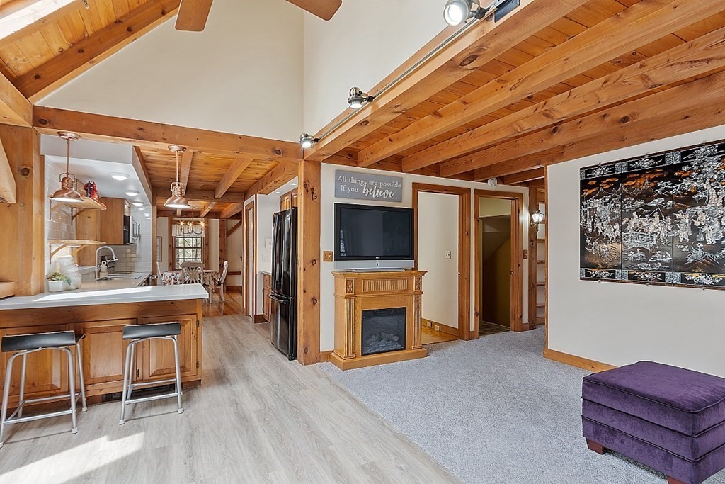 149 Walker Pond Road Sturbridge, MA 01566 - Photo 4 of 42 a living room with furniture a flat screen tv and a table