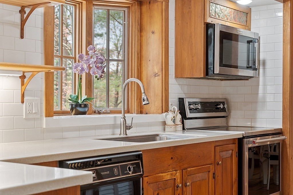 149 Walker Pond Road Sturbridge, MA 01566 - Photo 6 of 42 a kitchen with stainless steel appliances a sink stove and cabinets