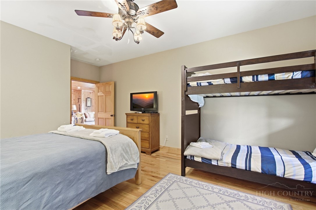 2081 Blackberry Road Boone, NC 28607 - Photo 43 of 45 a bedroom with a bed and a chandelier