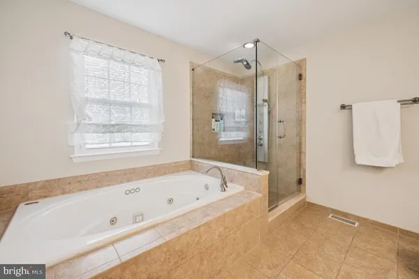 a spacious bathroom with a granite countertop sink mirror and vanity