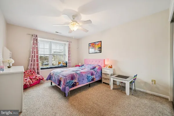 a bedroom with bed and window
