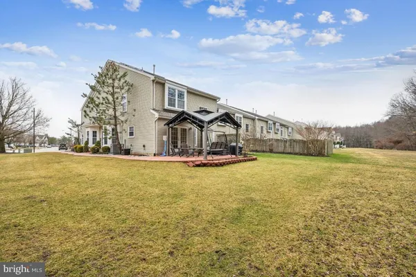 a front view of a house with swimming pool having outdoor seating