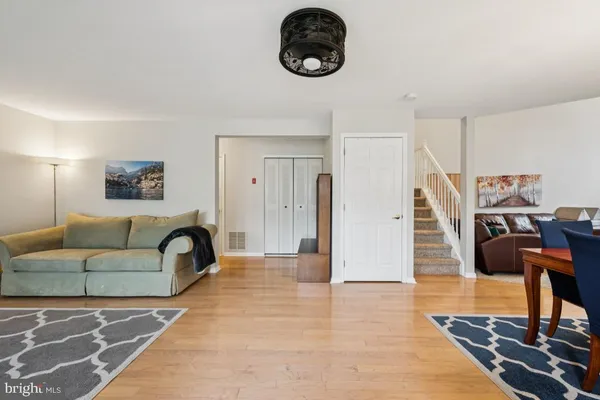 a living room with furniture a rug and a clock