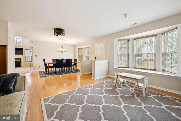a living room with furniture a rug and a large window