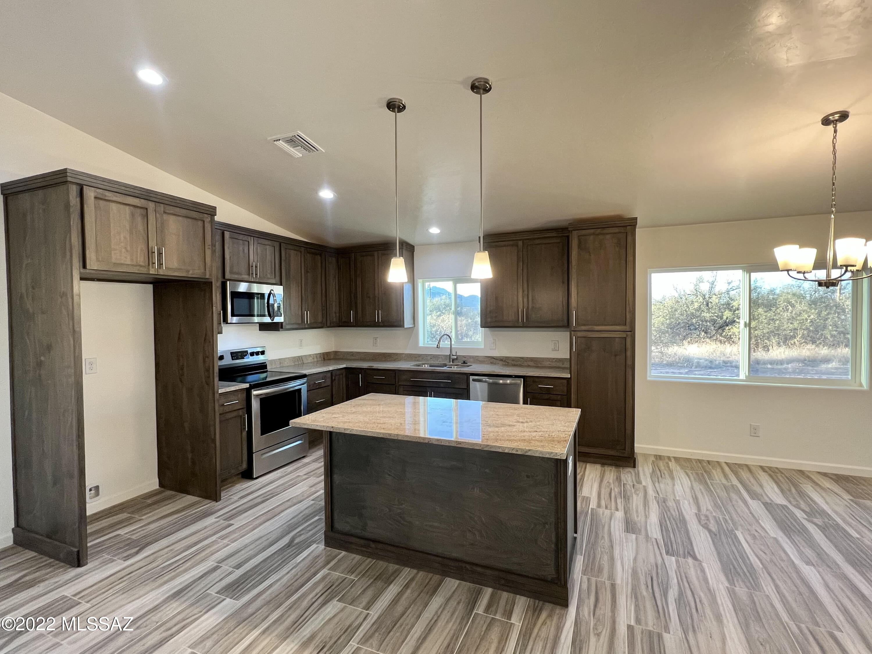 1696 Camino Barrera Rio Rico, AZ 85648 - Photo 4 of 30 a kitchen with stainless steel appliances granite countertop a sink a stove and a refrigerator