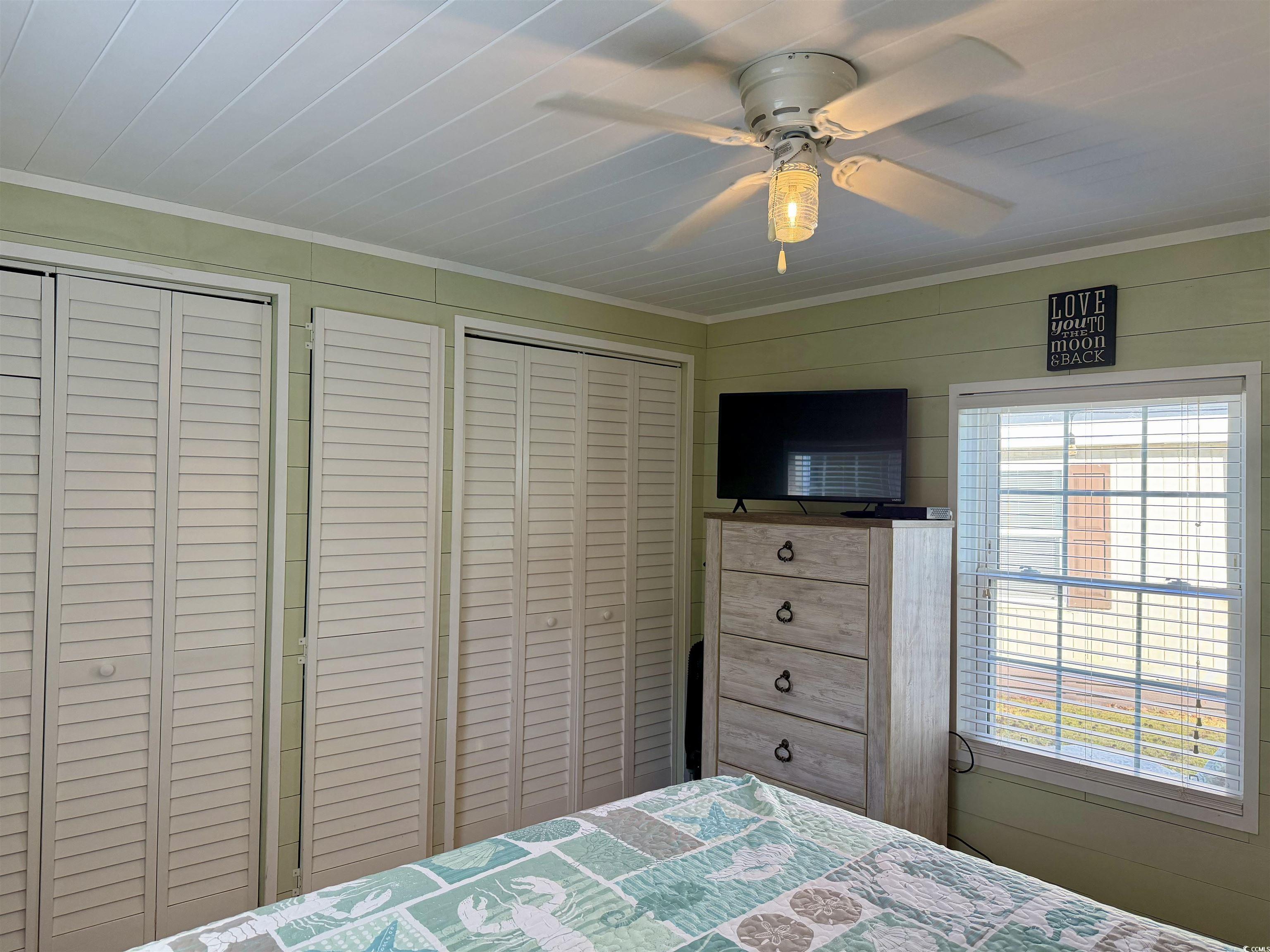 292 Flamingo Surfside Beach, SC 29575 - Photo 12 of 32 Bedroom with ceiling fan, crown molding, and multiple closets