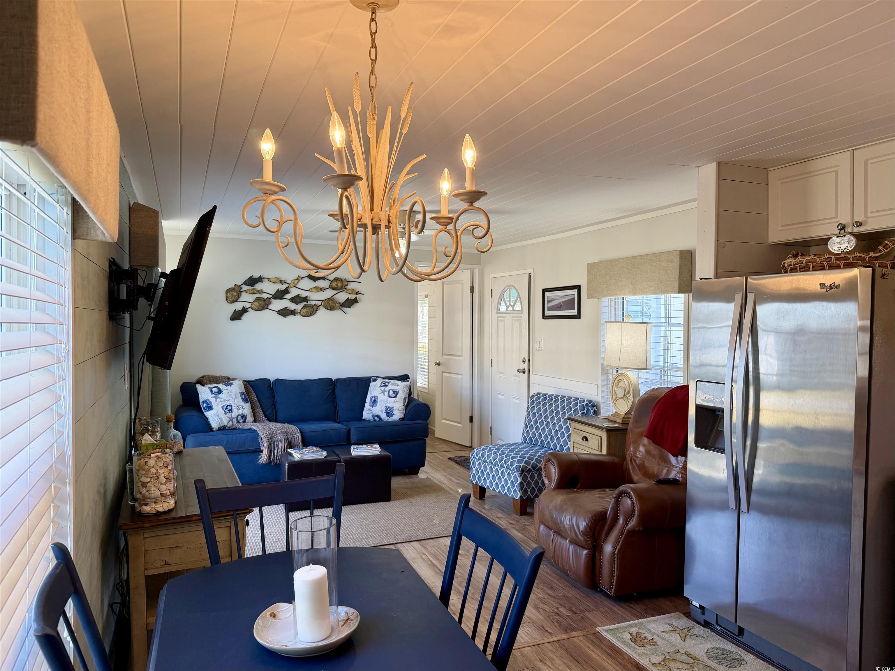 292 Flamingo Surfside Beach, SC 29575 - Photo 16 of 32 Dining space with a chandelier, wood finished floors, and ornamental molding