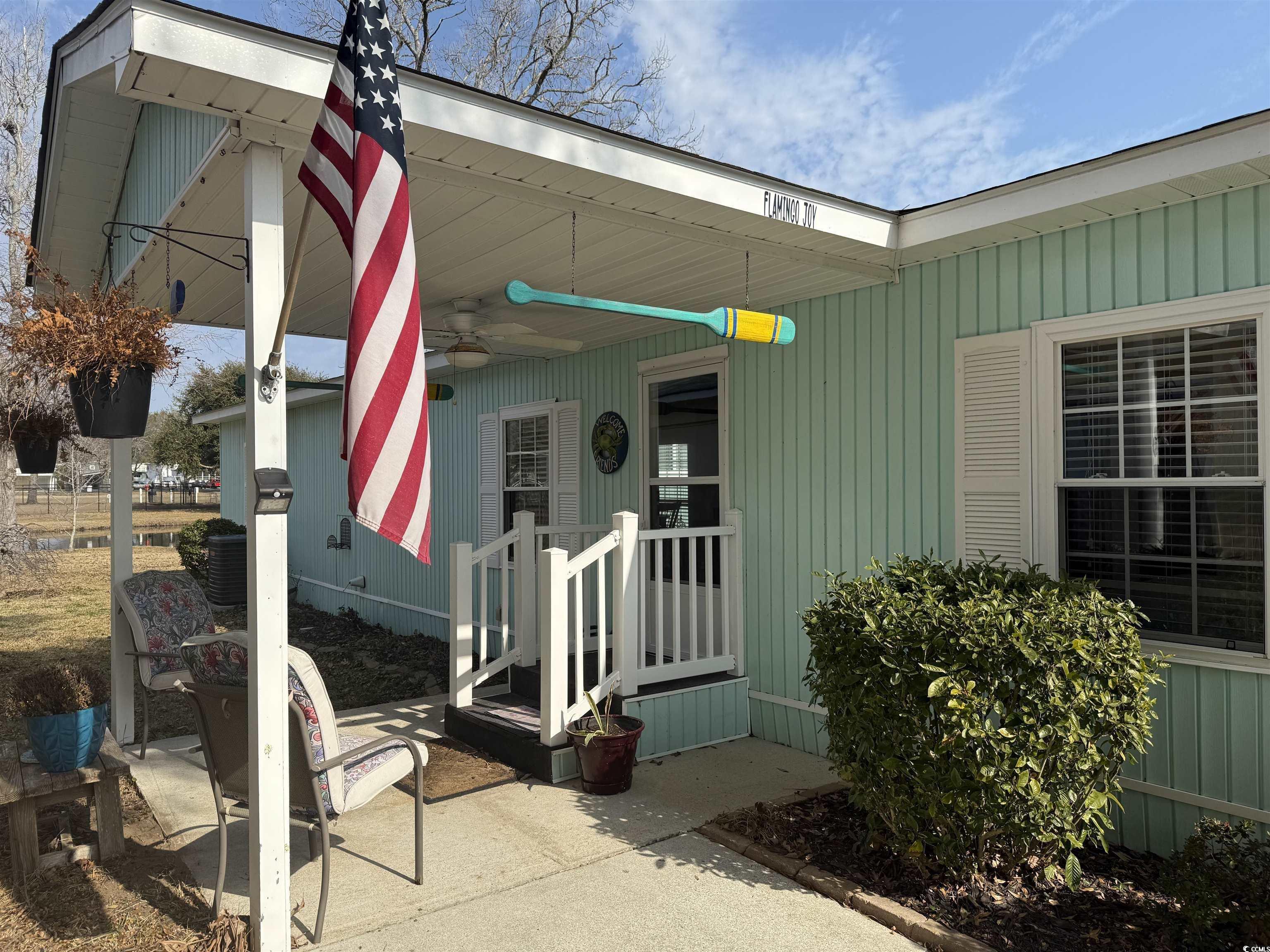 292 Flamingo Surfside Beach, SC 29575 - Photo 19 of 32 View of exterior entry featuring ceiling fan and covered porch