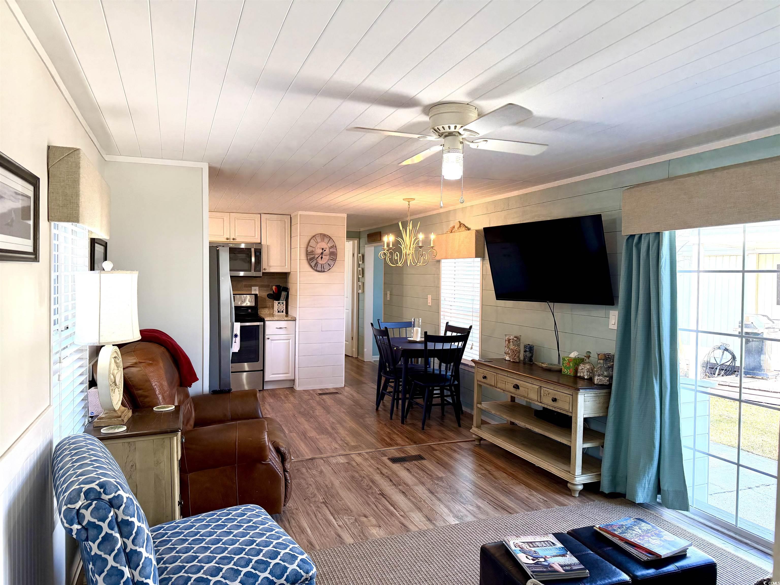 292 Flamingo Surfside Beach, SC 29575 - Photo 2 of 32 Living room with ornamental molding, dark wood-type flooring, ceiling fan, a chandelier, and wood ceiling
