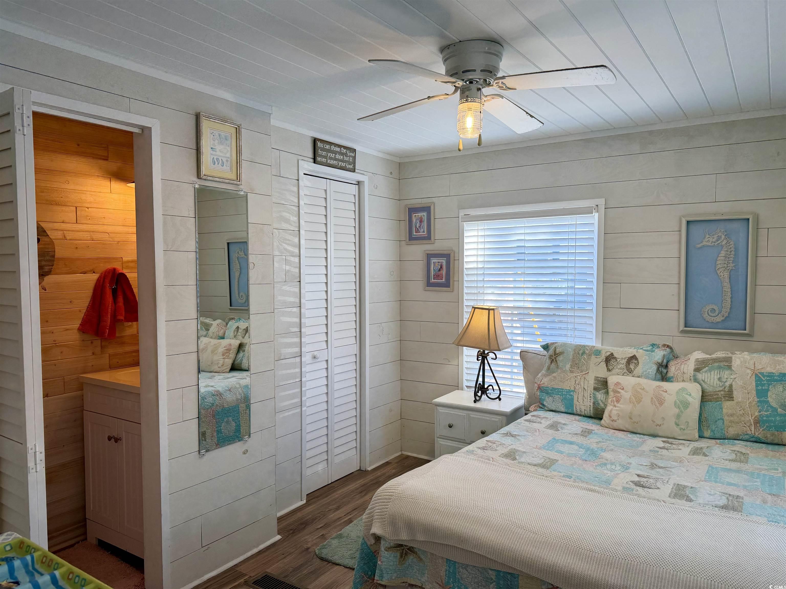 292 Flamingo Surfside Beach, SC 29575 - Photo 3 of 32 Bedroom with wooden walls, dark wood-style flooring, ceiling fan, and wood ceiling