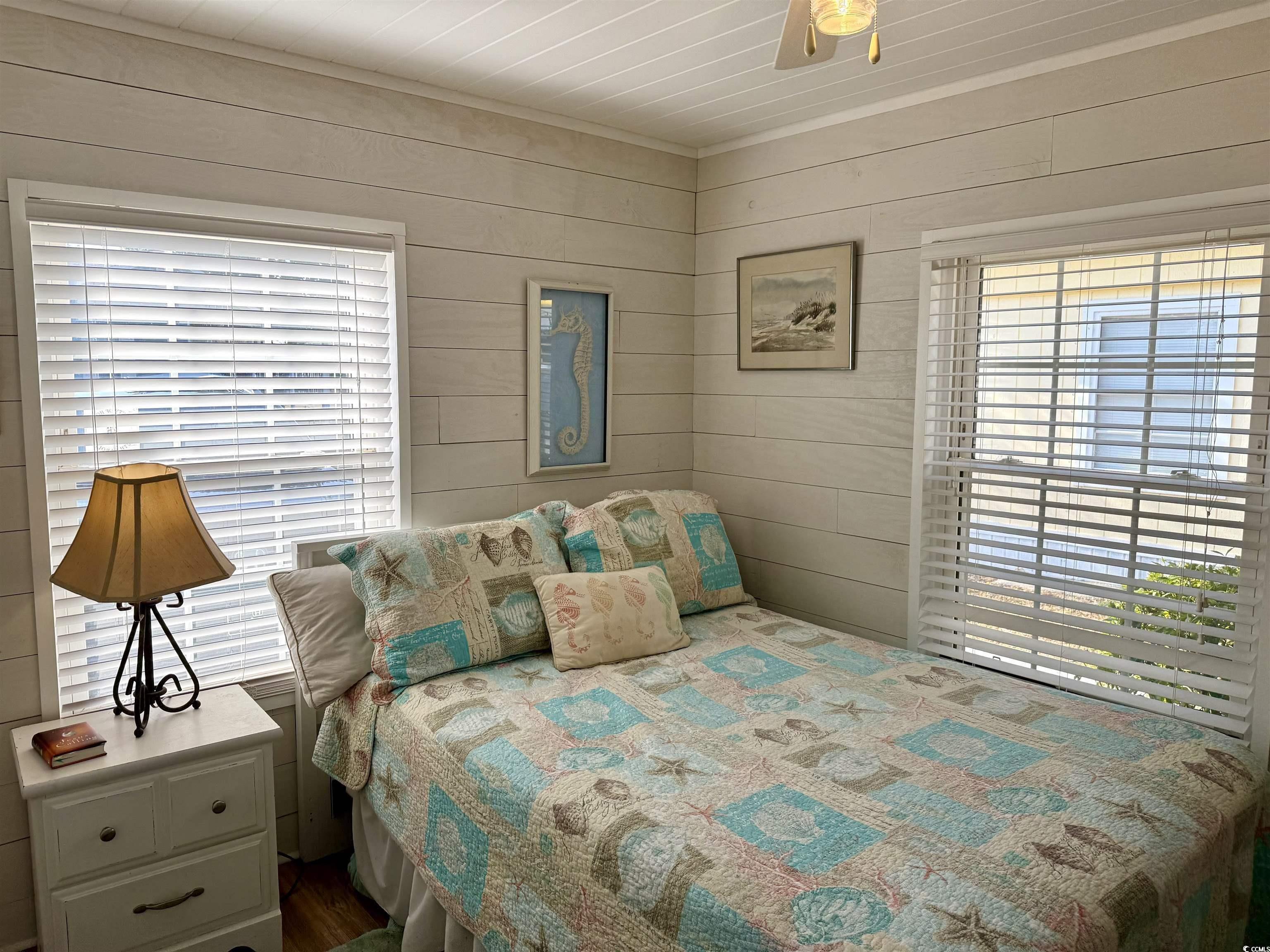 292 Flamingo Surfside Beach, SC 29575 - Photo 5 of 32 Bedroom featuring wood walls, multiple windows, and wooden ceiling