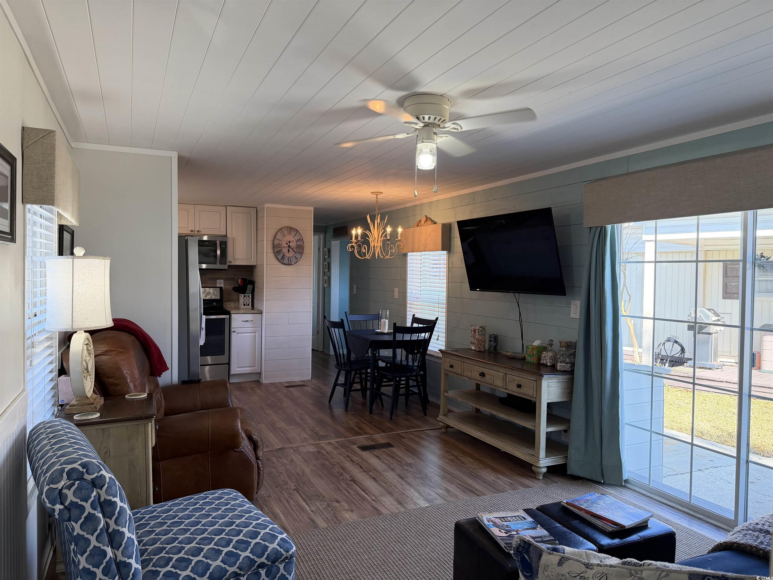 292 Flamingo Surfside Beach, SC 29575 - Photo 6 of 32 Living area with crown molding, dark wood-type flooring, a ceiling fan, a chandelier, and wood ceiling