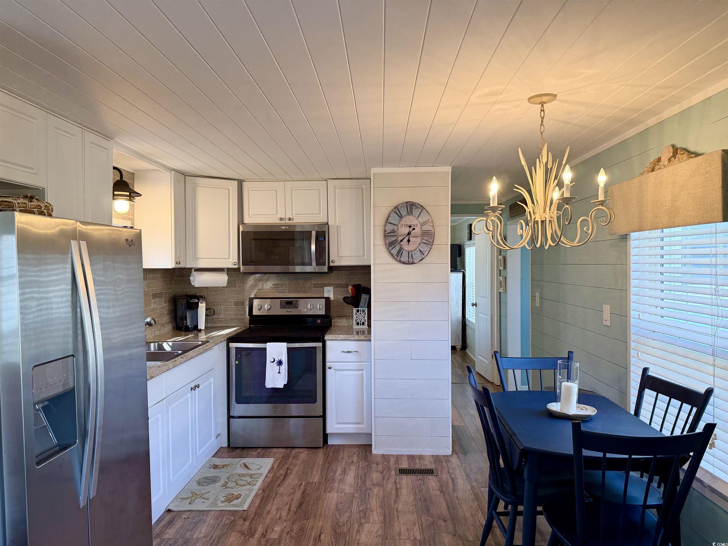 292 Flamingo Surfside Beach, SC 29575 - Photo 7 of 32 Kitchen featuring stainless steel appliances, pendant lighting, white cabinets, wood ceiling, and dark wood-style flooring