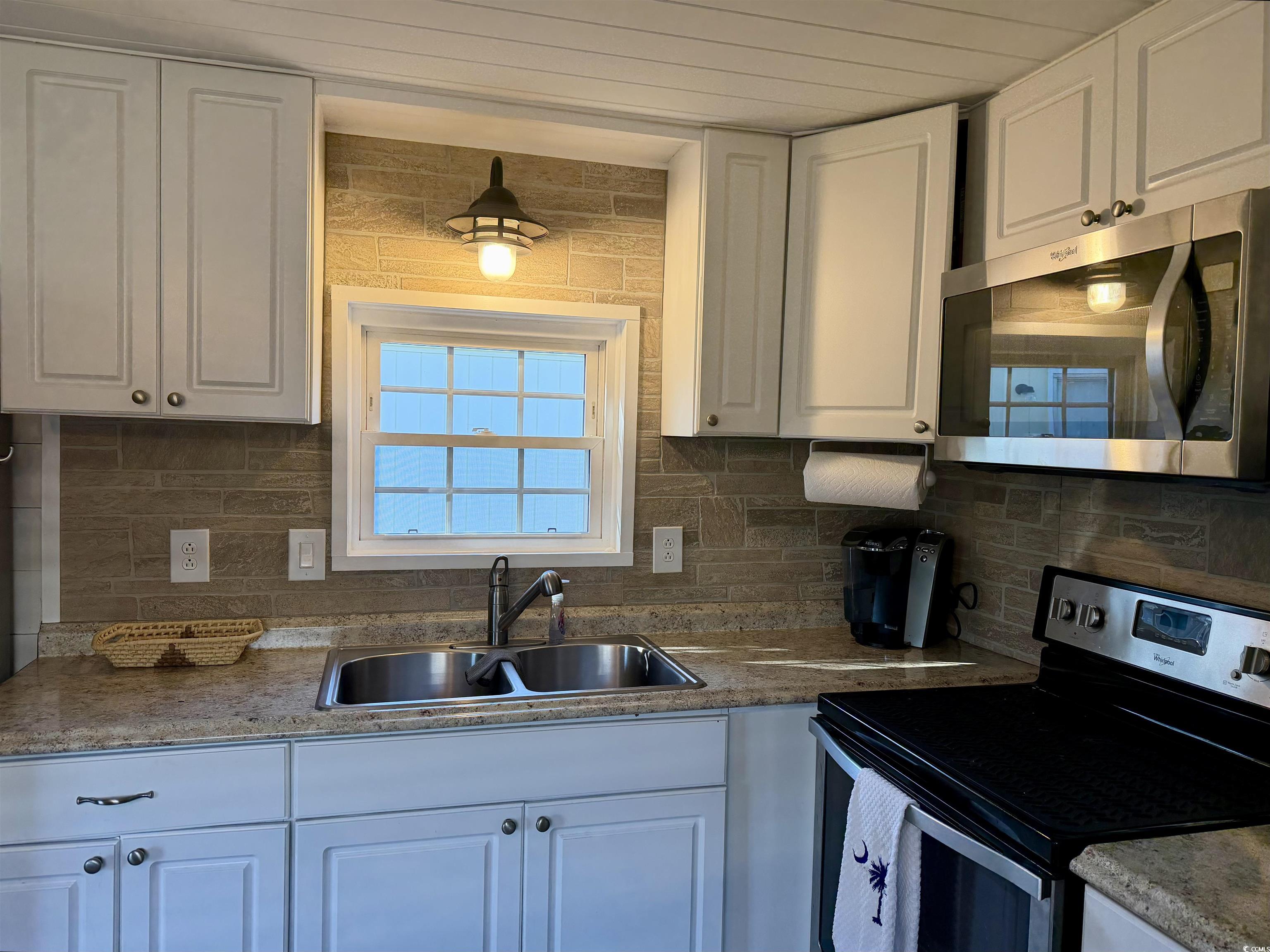 292 Flamingo Surfside Beach, SC 29575 - Photo 9 of 32 Kitchen with stainless steel appliances, white cabinetry, and backsplash