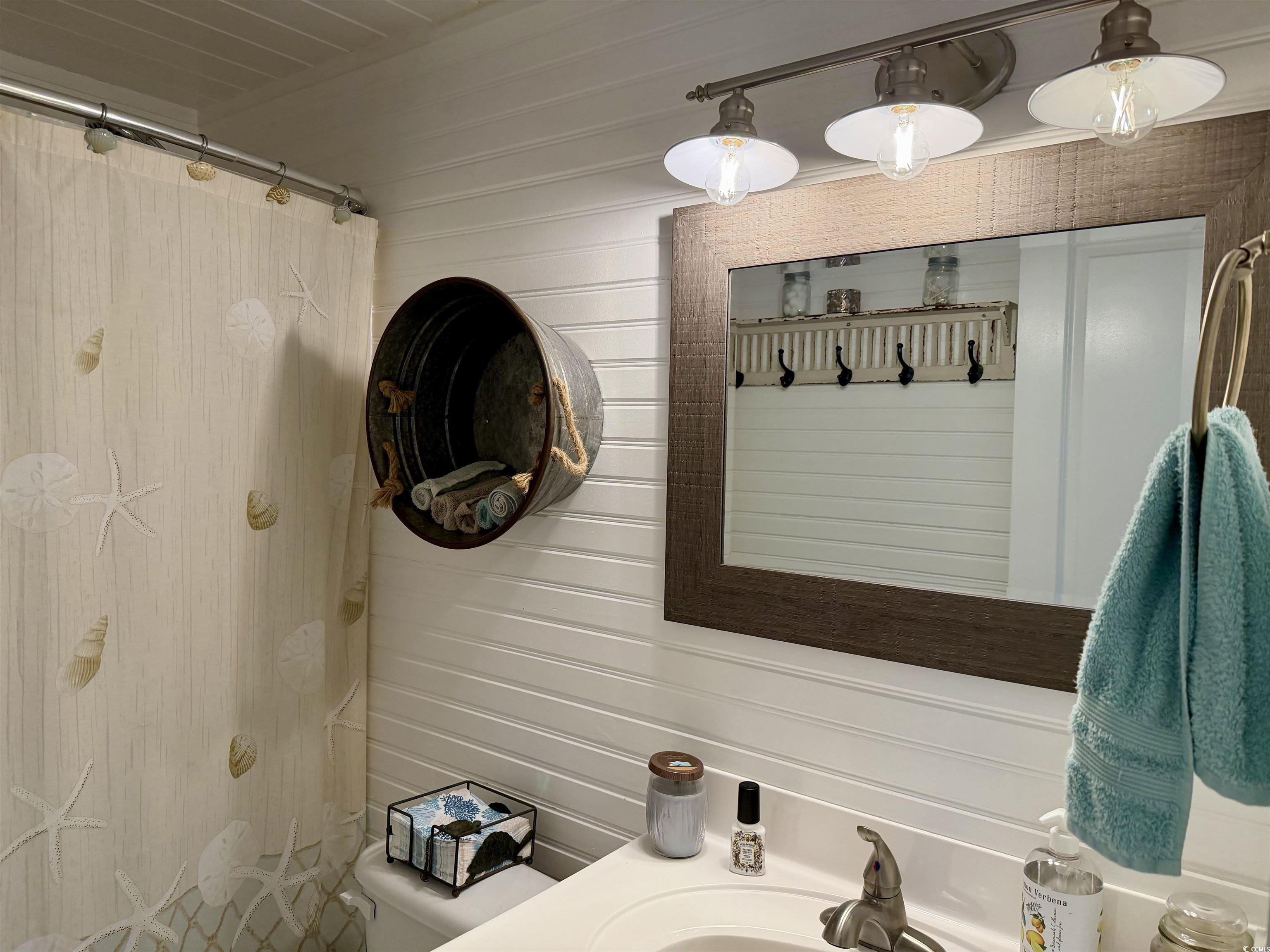 292 Flamingo Surfside Beach, SC 29575 - Photo 10 of 32 Full bath with vanity, curtained shower, and wood walls