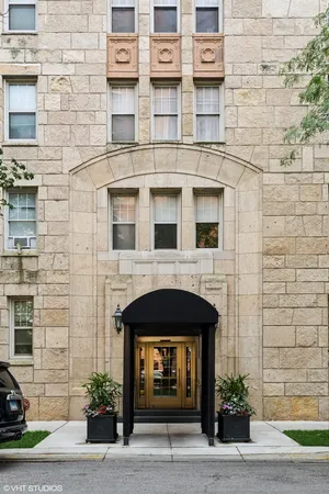 a front view of a building with a garden