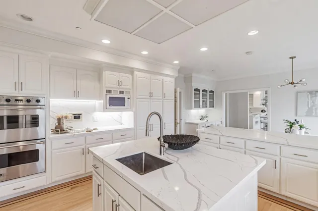 a bed sitting in a bedroom next to a window and dresser