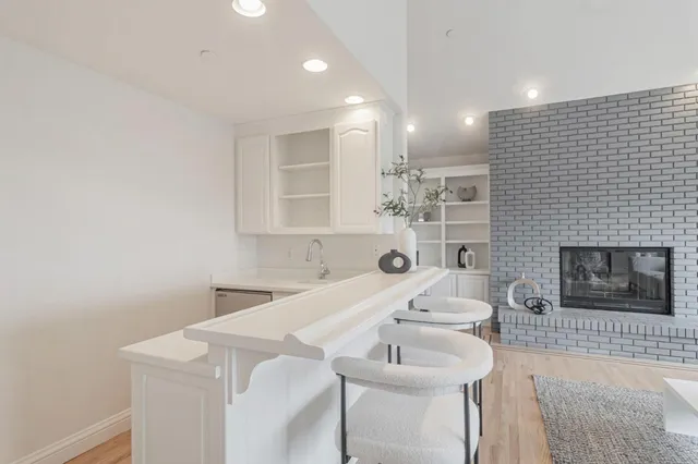an aerial view of a house with balcony and trees al around