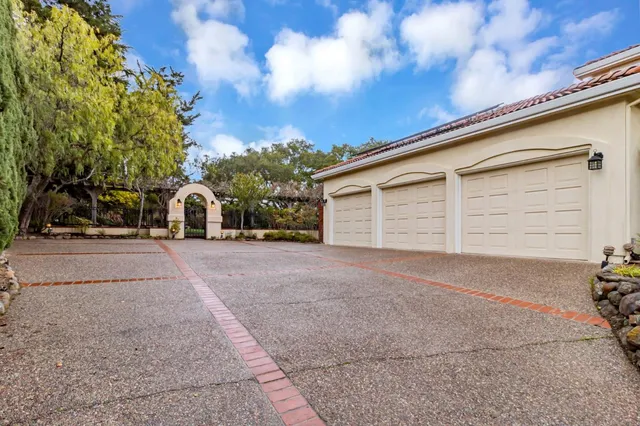 a living room with furniture a fireplace and a large window