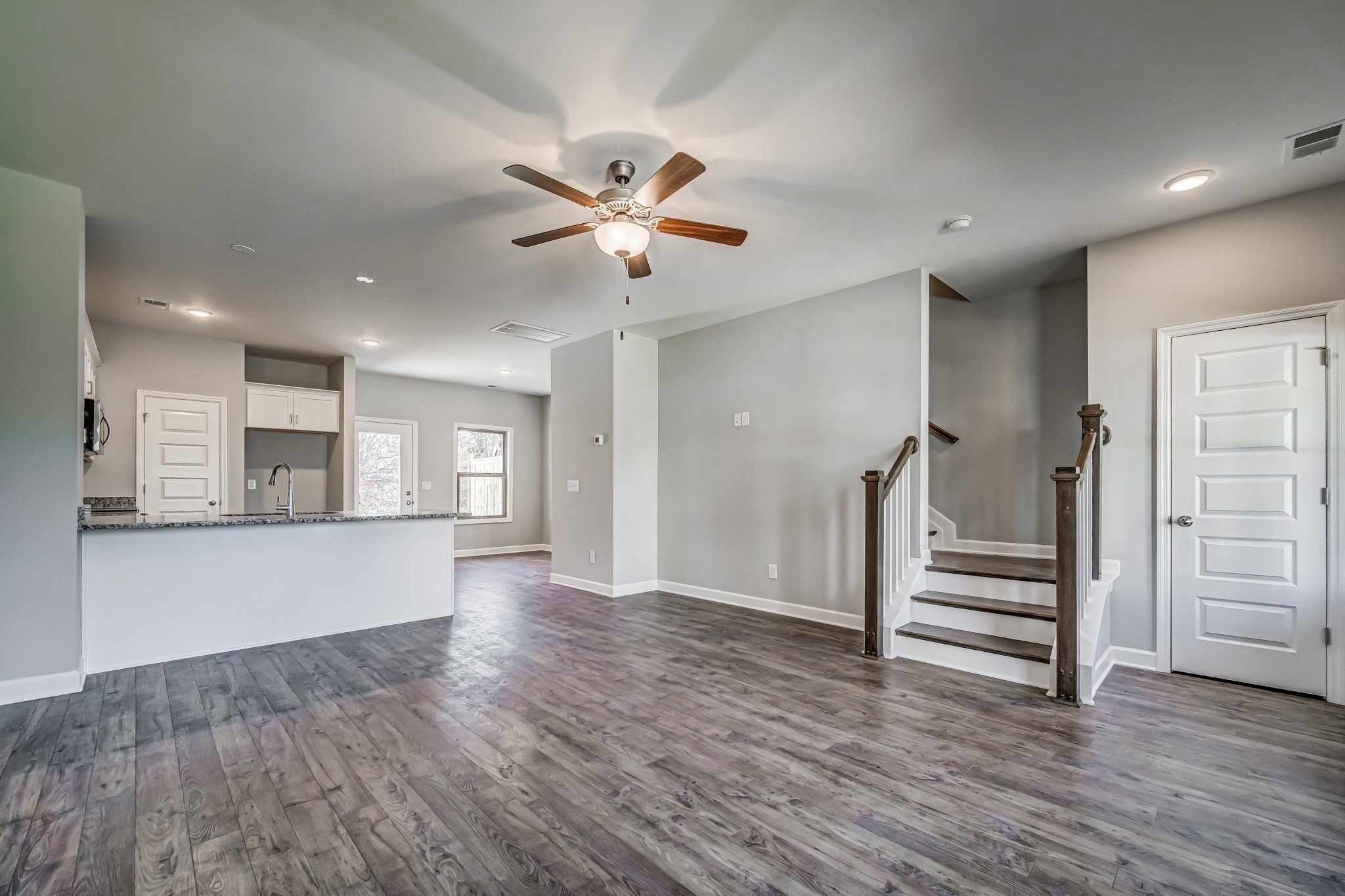 1746 Fenway Loop Antioch, TN 37013 - Photo 10 of 15 a view of an empty room with wooden floor and a ceiling fan