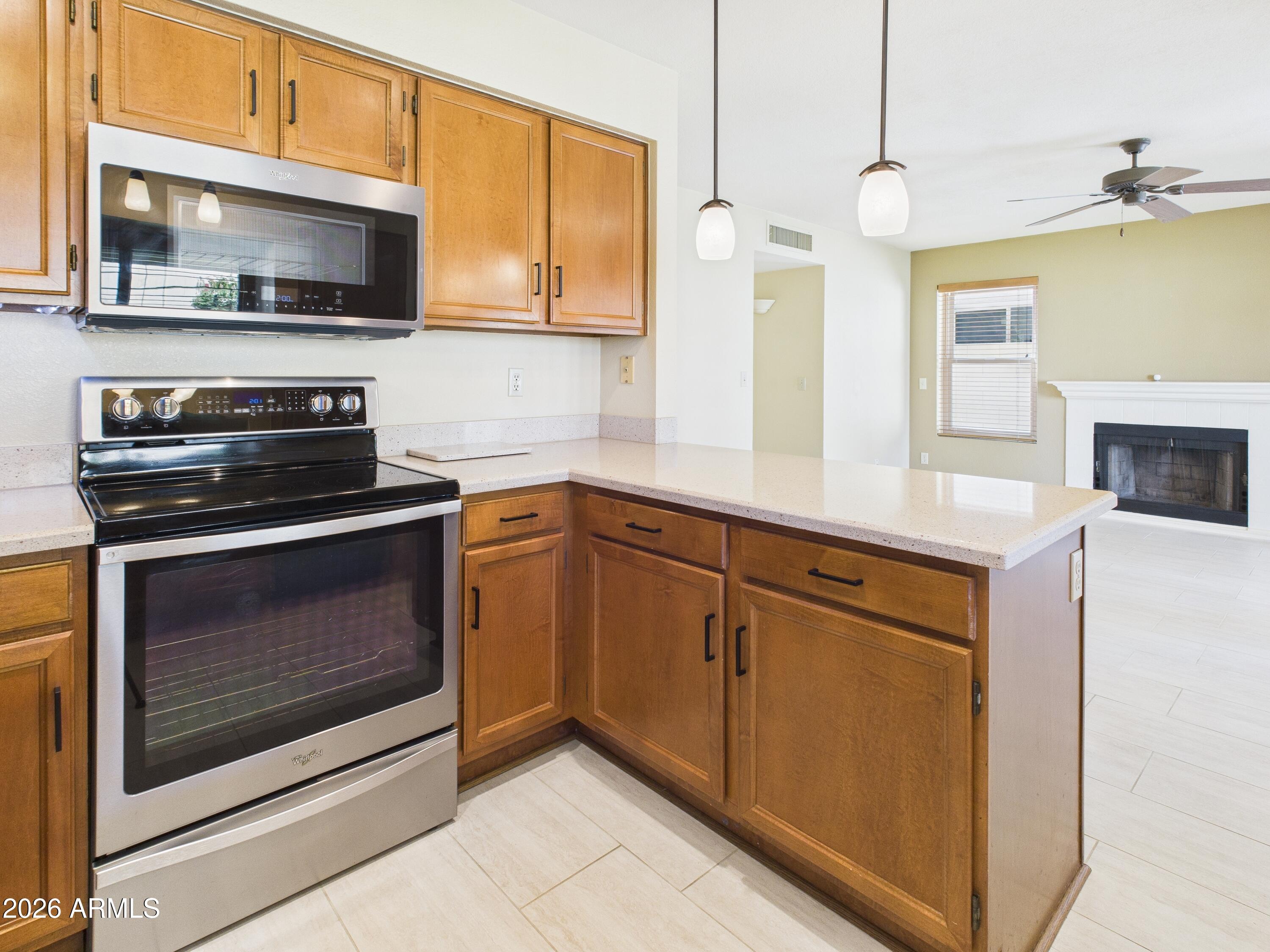 2750 East Rock Wren Road Phoenix, AZ 85048 - Photo 10 of 90 a kitchen with stainless steel appliances granite countertop a stove microwave and oven