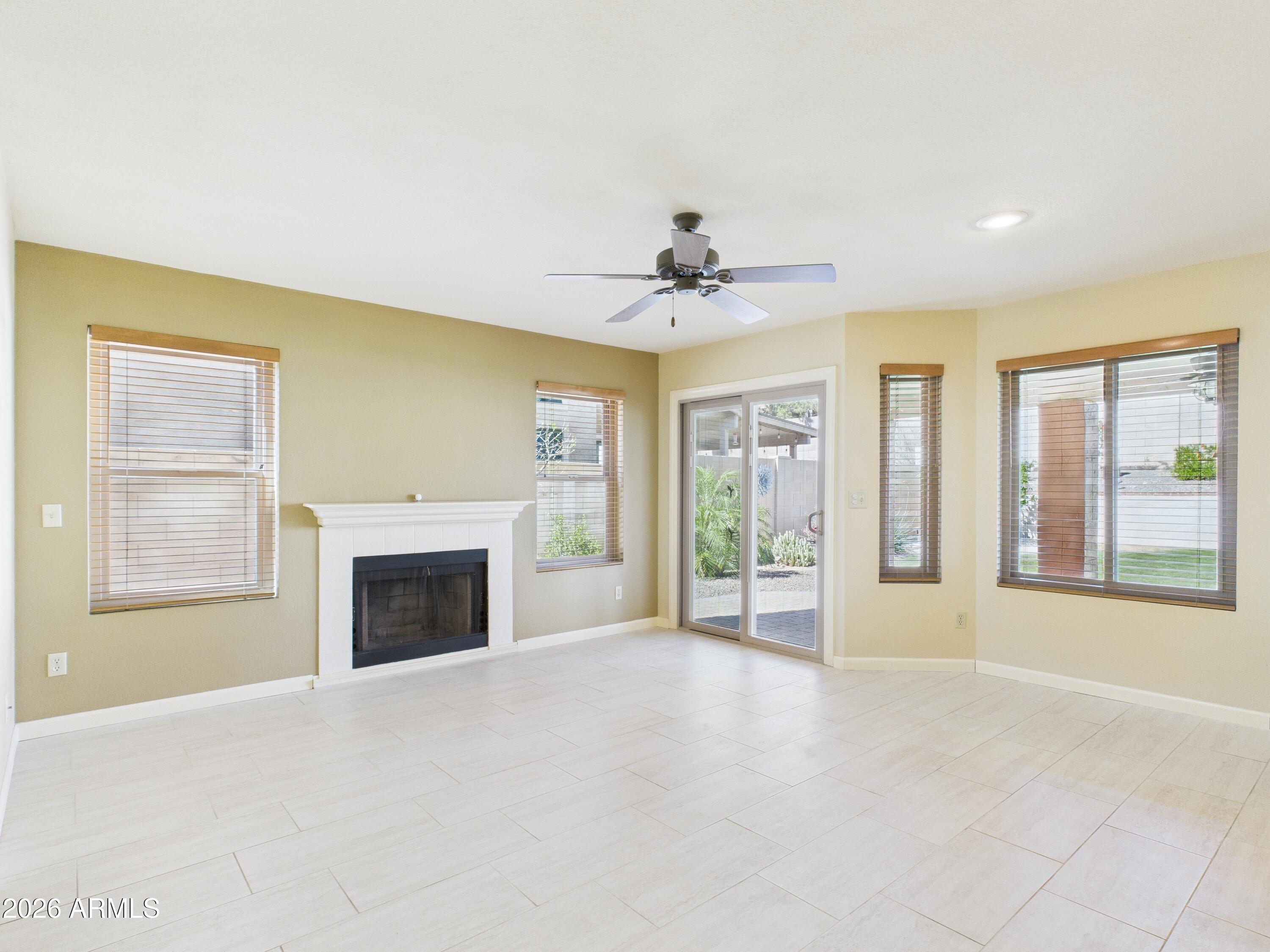 2750 East Rock Wren Road Phoenix, AZ 85048 - Photo 20 of 90 a view of an empty room with a fireplace and a window