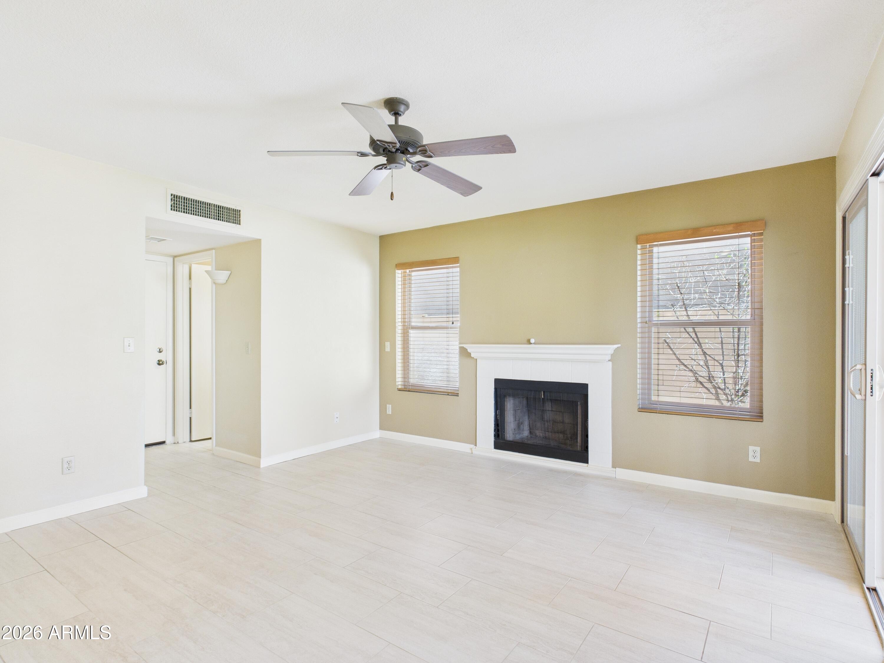 2750 East Rock Wren Road Phoenix, AZ 85048 - Photo 22 of 90 a view of an empty room with a fireplace