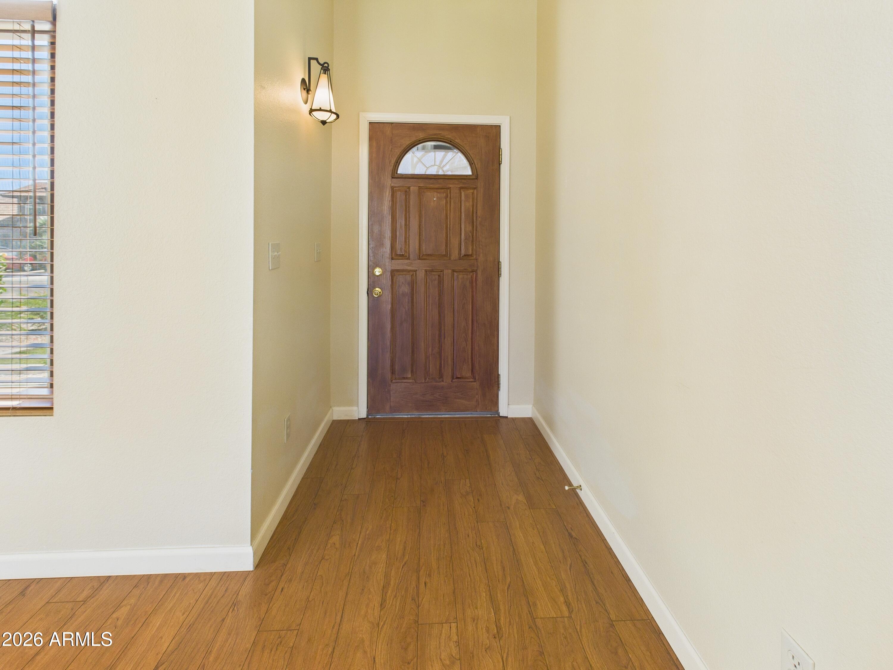 2750 East Rock Wren Road Phoenix, AZ 85048 - Photo 25 of 90 a view of a hallway with wooden floor