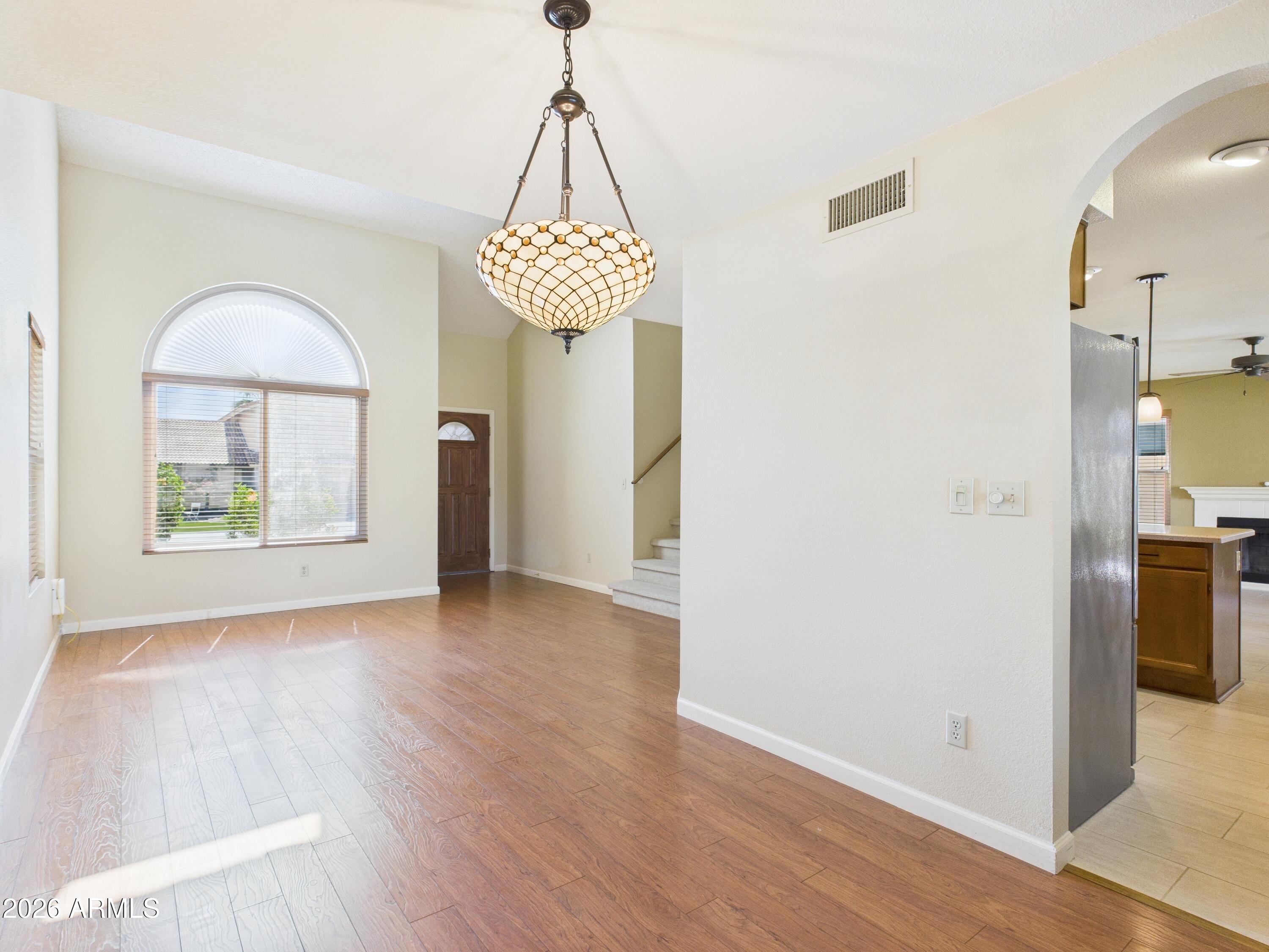 2750 East Rock Wren Road Phoenix, AZ 85048 - Photo 29 of 90 a view of a room with wooden floor chandelier and a chandelier