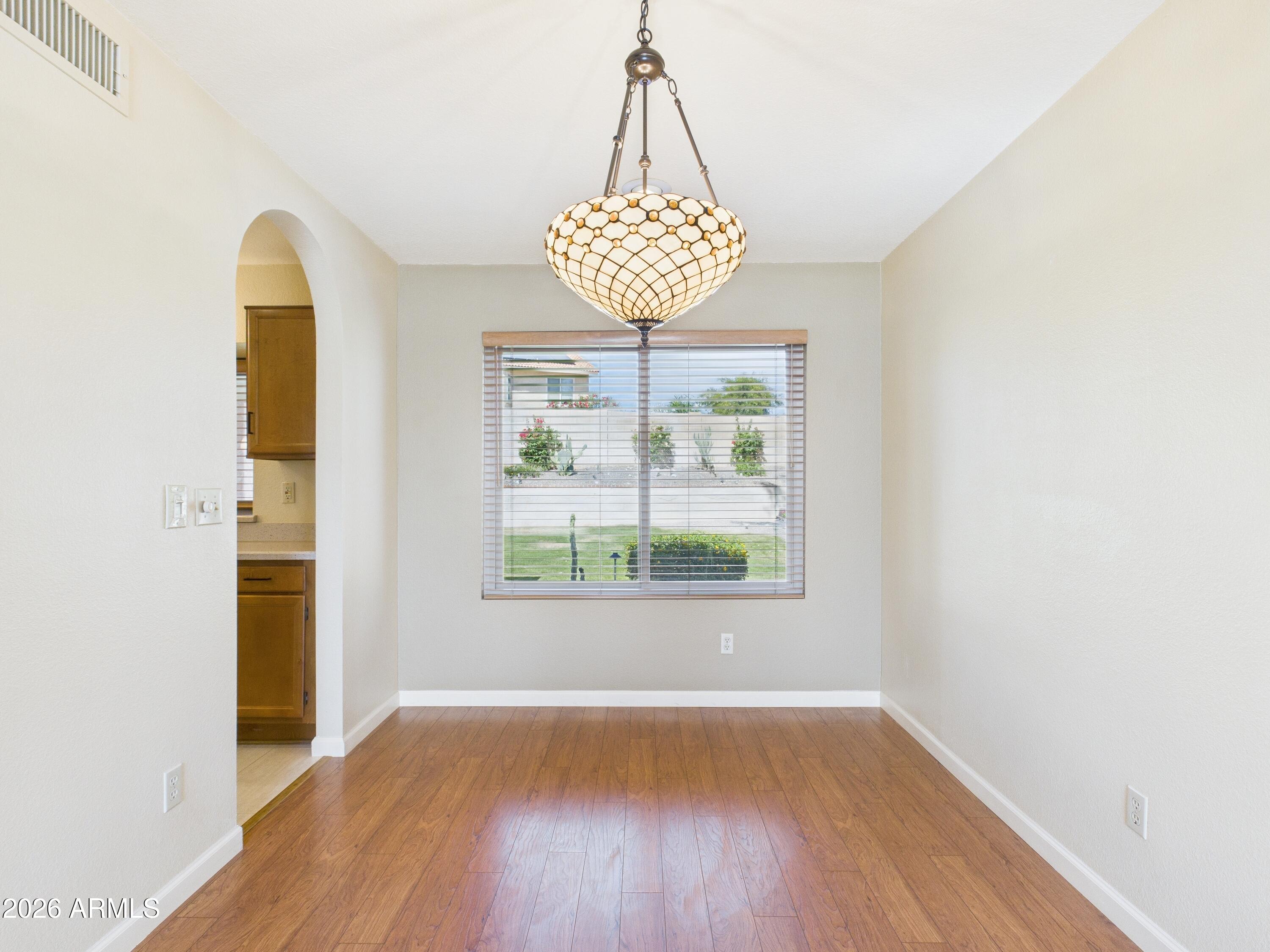 2750 East Rock Wren Road Phoenix, AZ 85048 - Photo 30 of 90 a view of an empty room with wooden floor and a window