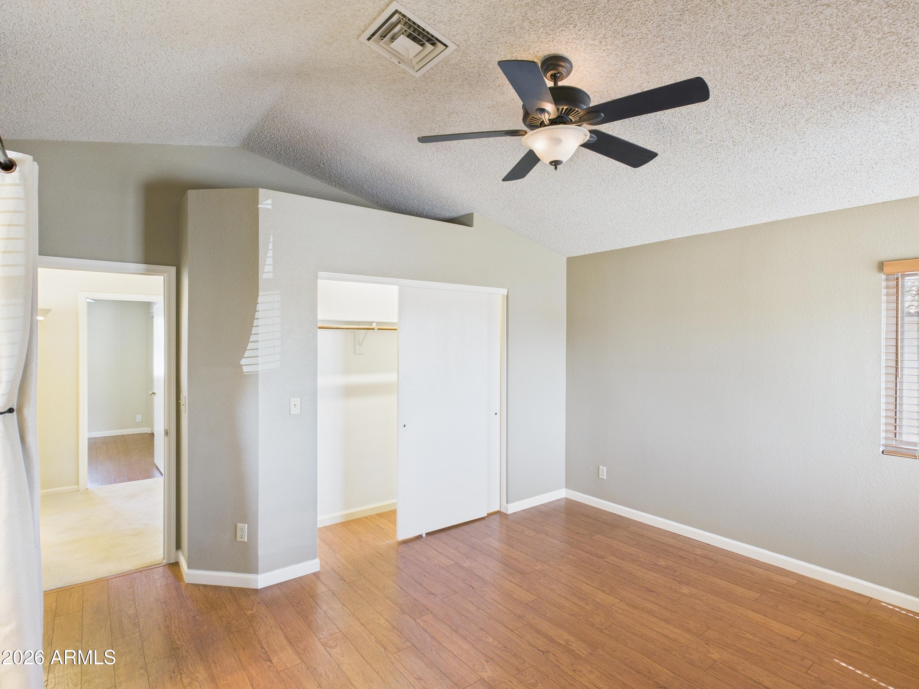 2750 East Rock Wren Road Phoenix, AZ 85048 - Photo 31 of 90 a view of an empty room with wooden floor