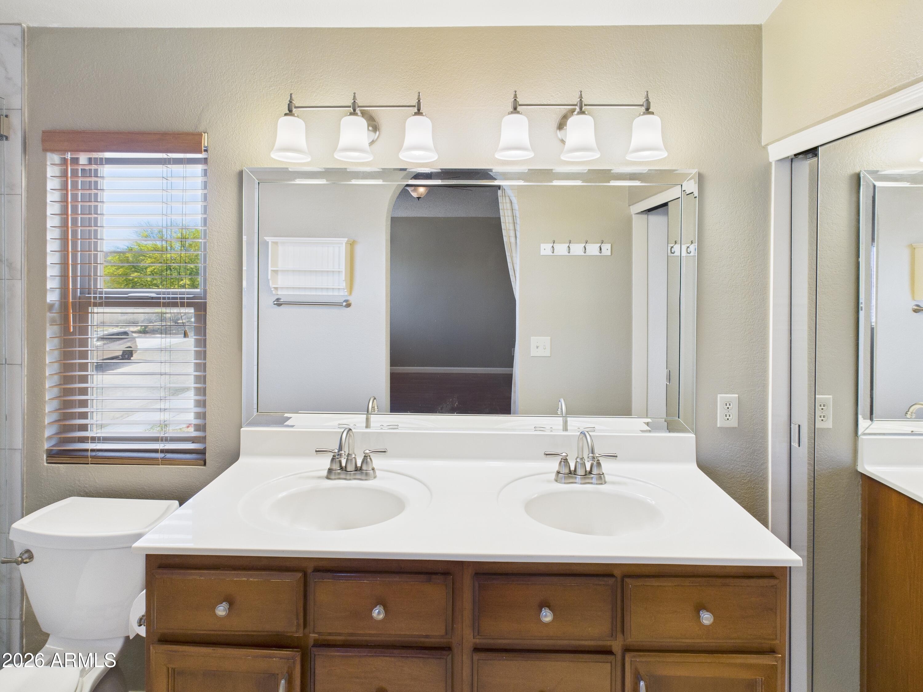 2750 East Rock Wren Road Phoenix, AZ 85048 - Photo 35 of 90 a bathroom with a sink double vanity and a mirror