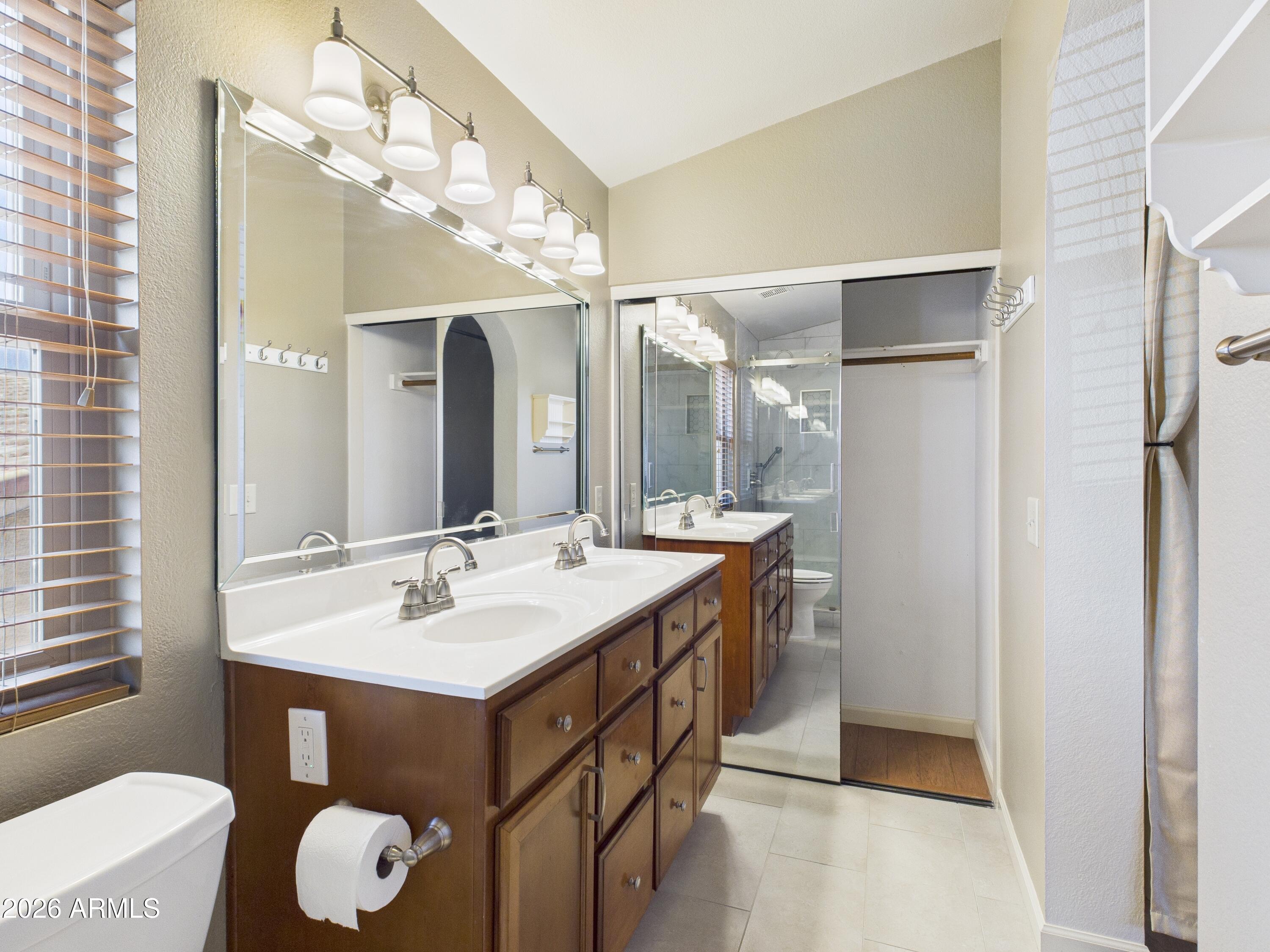 2750 East Rock Wren Road Phoenix, AZ 85048 - Photo 39 of 90 a bathroom with a sink vanity and a mirror