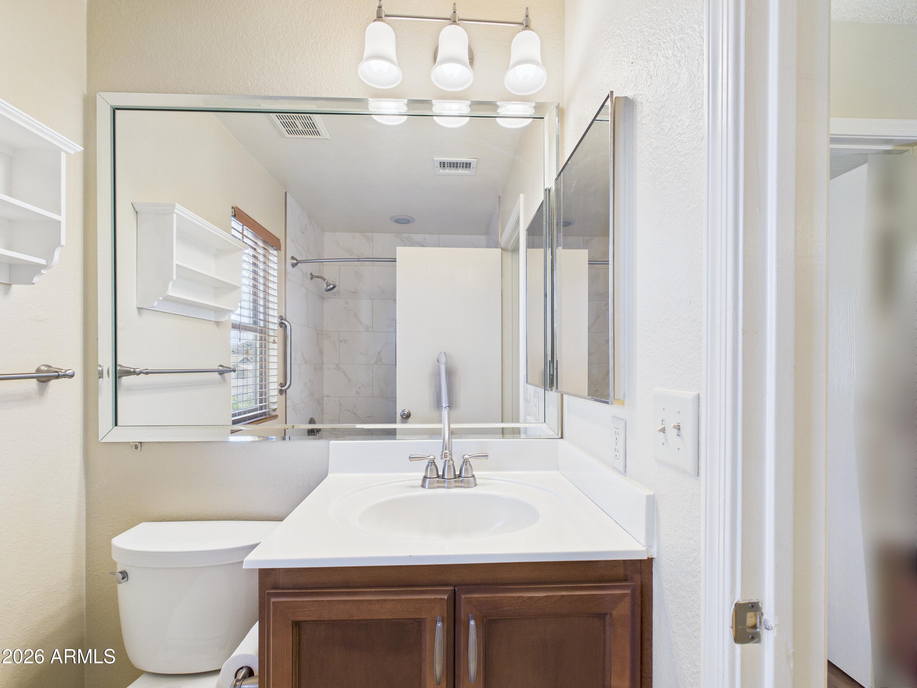 2750 East Rock Wren Road Phoenix, AZ 85048 - Photo 43 of 90 a bathroom with a sink vanity mirror and toilet