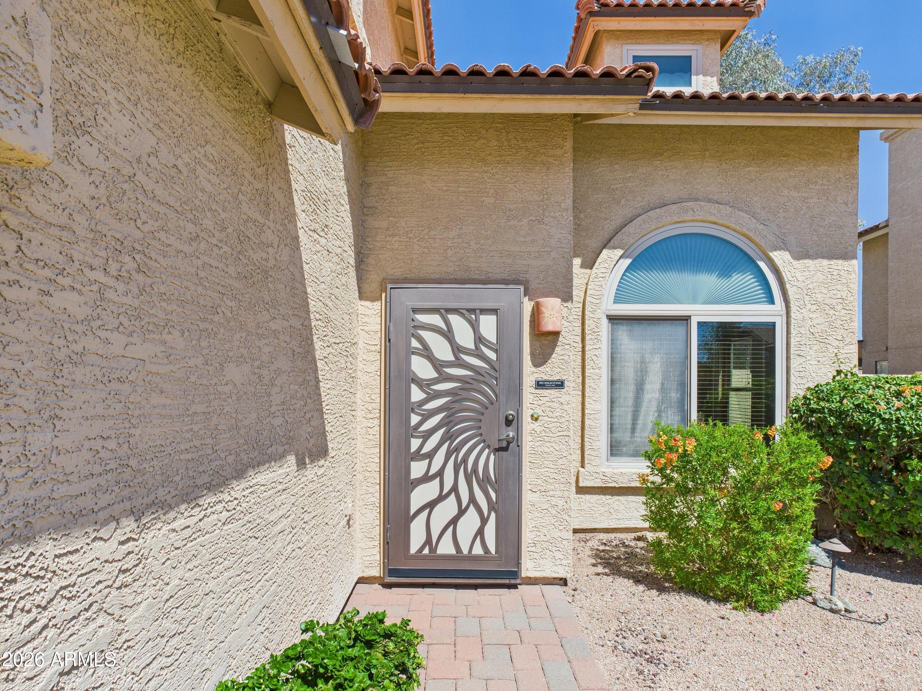 2750 East Rock Wren Road Phoenix, AZ 85048 - Photo 4 of 90 a front view of a house with a garden