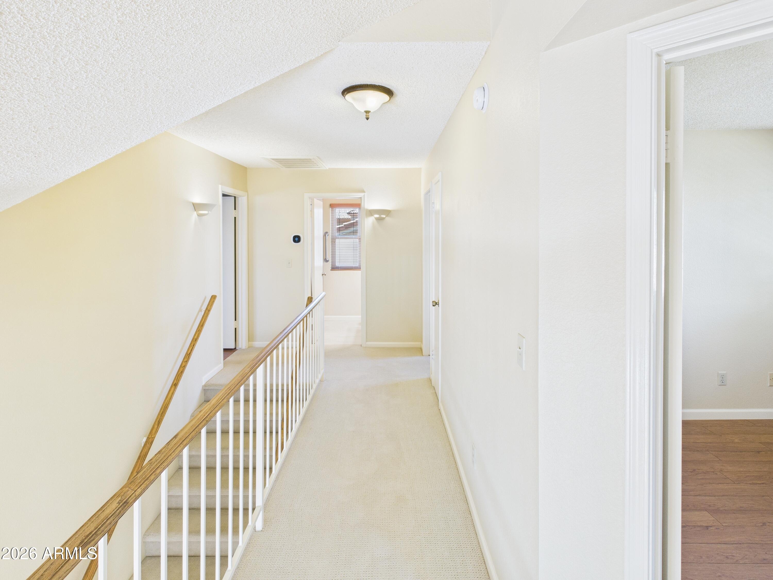 2750 East Rock Wren Road Phoenix, AZ 85048 - Photo 52 of 90 a view of a hallway with wooden floor and staircase