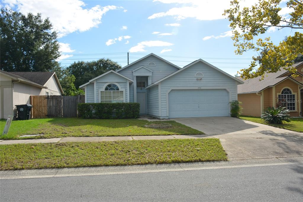 1932 Grasmere Drive Apopka, FL 32703 - Photo 1 of 1 a front view of a house with a garden