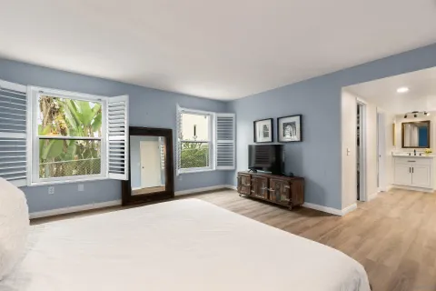 a living room with a wooden floor and a flat screen tv